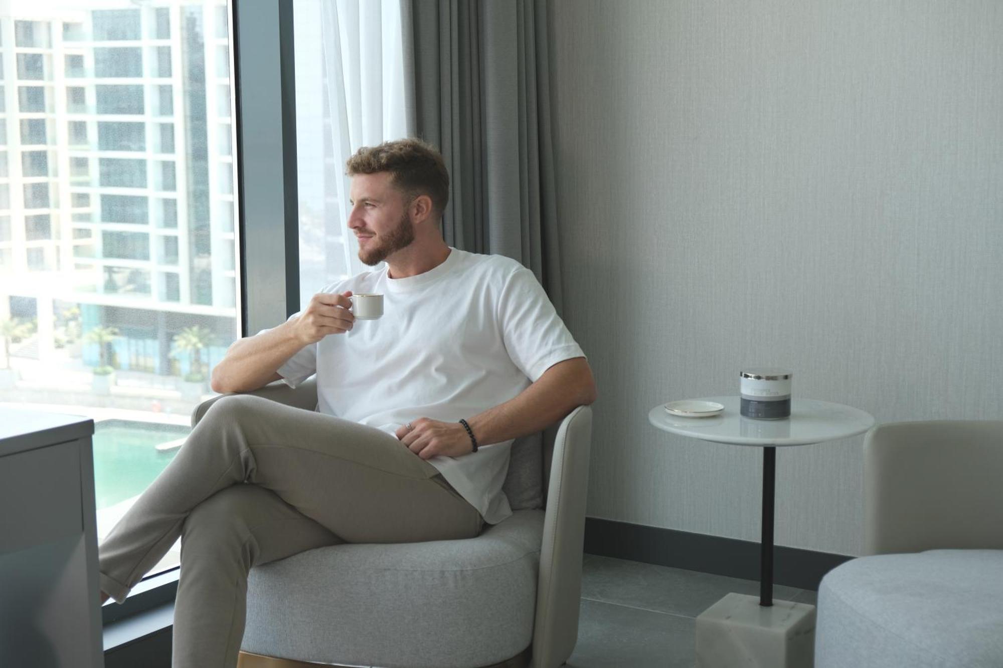 Charthouse Bahrain Hotel Manama Exterior photo A man drinking coffee